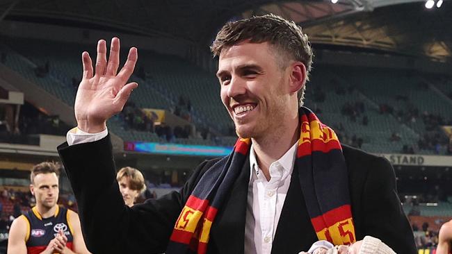 ADELAIDE, AUSTRALIA - AUGUST 19: Paul Seedsman of the Crows walks off the oval with his baby - retiring during to concussion during the 2023 AFL Round 23 match between the Adelaide Crows and the Sydney Swans at Adelaide Oval on August 19, 2023 in Adelaide, Australia. (Photo by Sarah Reed/AFL Photos via Getty Images)