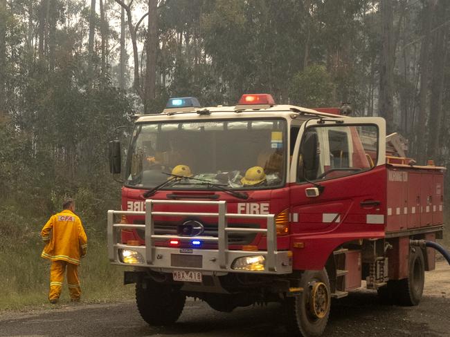 MALLACOOTA  AUSTRALIA - JANUARY 15:  Fire trucks refills with water along the Princes Highway near Mallacoota on January 15, 2020 , Australia. The Princes Highway between Mallacoota and Orbost remains closed to public due to the risk of falling trees following the devastating bushfires that have swept through East Gippsland in recent weeks. ADF armoured vehicles have been travelling the stretch of road to bring supplies in to Mallacoota, after the coastal town was cut off by fire on New Years Eve, forcing residents and holidaymakers to shelter on the beach. More than 1500 people were evacuated by Navy ships and helicopters to Melbourne in the following week.  Fires continue to burn across East Gippsland, with firefighters working to contain a number of blazes in the region. Four people have died and more than 1.3m hectares have been burned across the state following weeks of ongoing fires. (Photo by Luis Ascui/Getty Images)