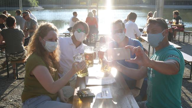 Guests enjoy the Seehaus beer garden in the English Garden park in Munich. Picture: Getty Images