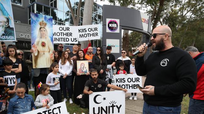 Protesters gather outside KIIS FM headquarters in North Ryde to protest against comments Kyle Sandilands made about Christians and the Virgin Mary. Protest leader Georgie Mark speaks to the protesters. Picture: David Swift