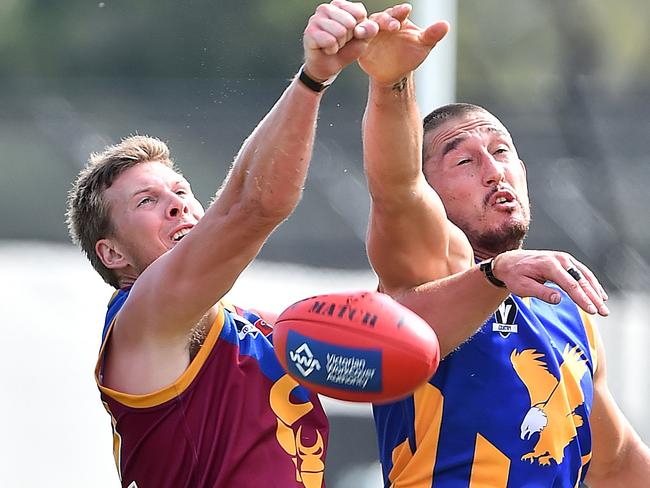 Pictured is action during the Nepean Football Netball League Australian Rules Football game Tyabb versus Somerville for the Bunguyan Shield - Tyabb in maroon, royal blue and gold with maroon shorts versus Somerville in royal blue and gold and white shorts at Bunguyan Reserve in Tyabb on 4 April 2015. Adrian Clay and Somerville player Scott Simpson. Picture: Derrick den Hollander