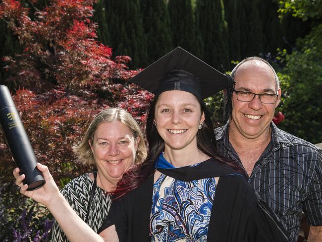 Bachelor of Nursing graduate Emily Burgon with parents Sue and Les Burgon at a UniSQ graduation ceremony at Empire Theatres, Tuesday, October 31, 2023. Picture: Kevin Farmer