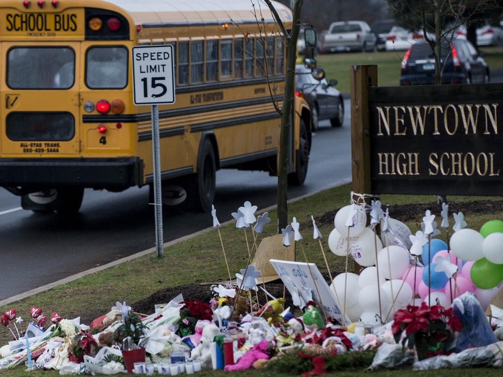 A school bus passes a makeshift memorial to the victims of the Sandy Hook Elementary School shooting December 18, 2012 in Newtown, Connecticut. Picture: AFP