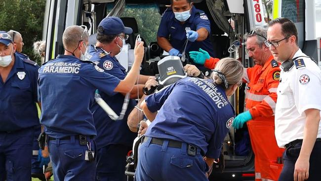 Paramedics prepare to take one victim to hospital. Picture: Frank Redward