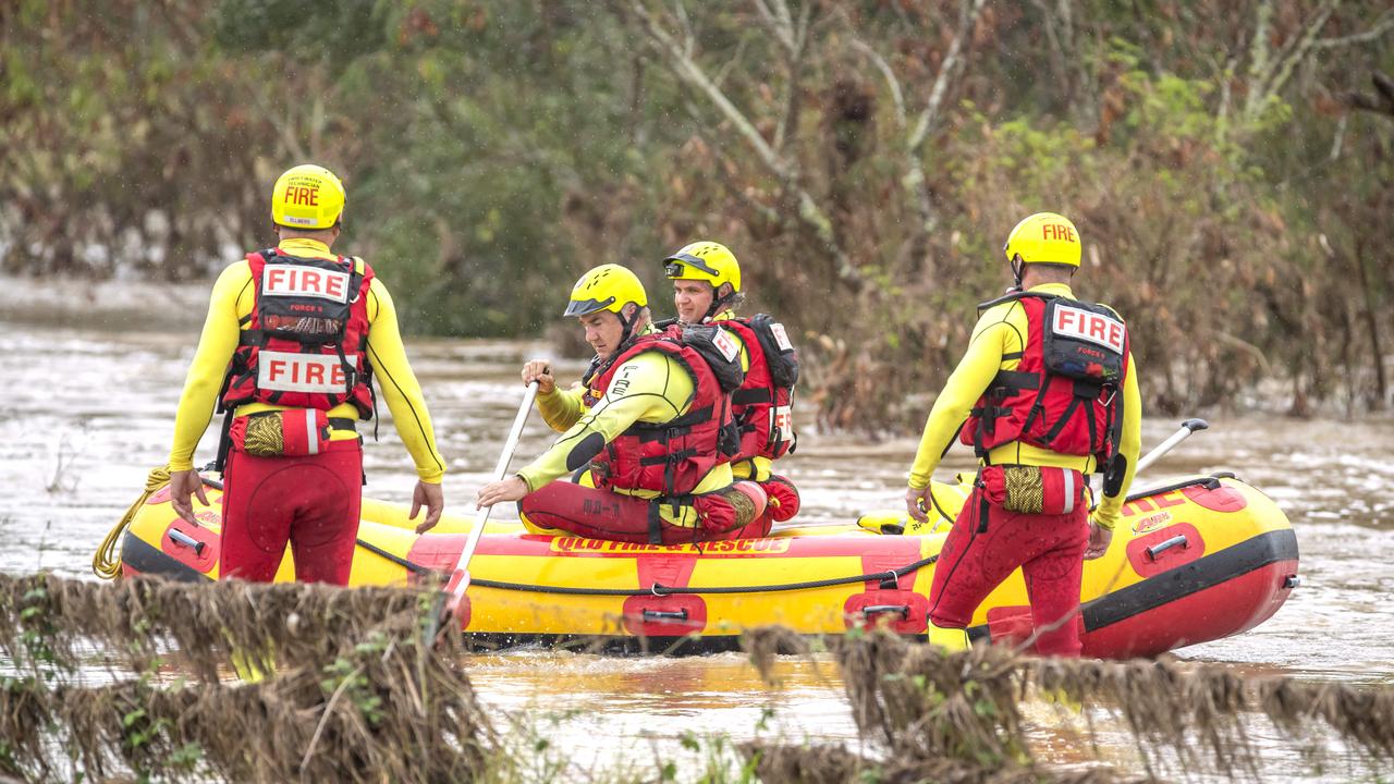 Queensland Fire and Emergency Services Swift Water Rescue check a car in floodwaters at Theuerkaufs Road, Fairney View, near Fernvale. Picture: Richard Walker