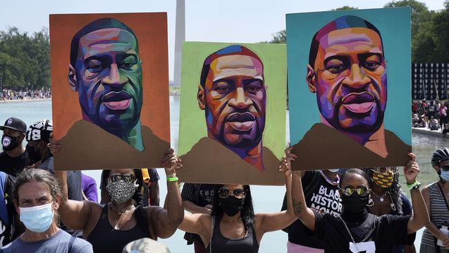 Black Lives Matter protesters hold images of George Floyd as they march in Washington. Picture: AFP