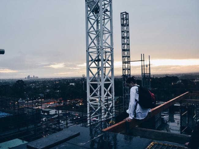 Young people trespass and climb the construction site for the Northern Beaches Hospital. Picture: Alfie Nevin