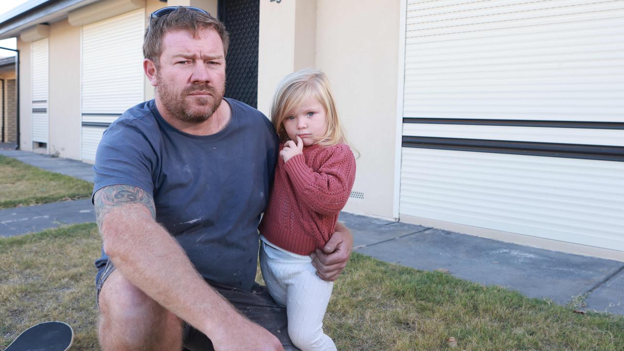 Simon Flaherty with Charlie 4, has been battling with his landlords over asbestos issues. Picture: Kelly Barnes