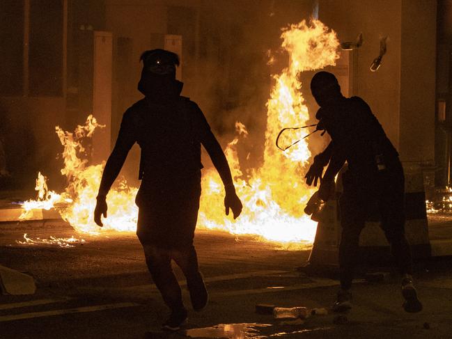 Protesters throw petrol bombs during protests in Hong Kong. Picture: AP