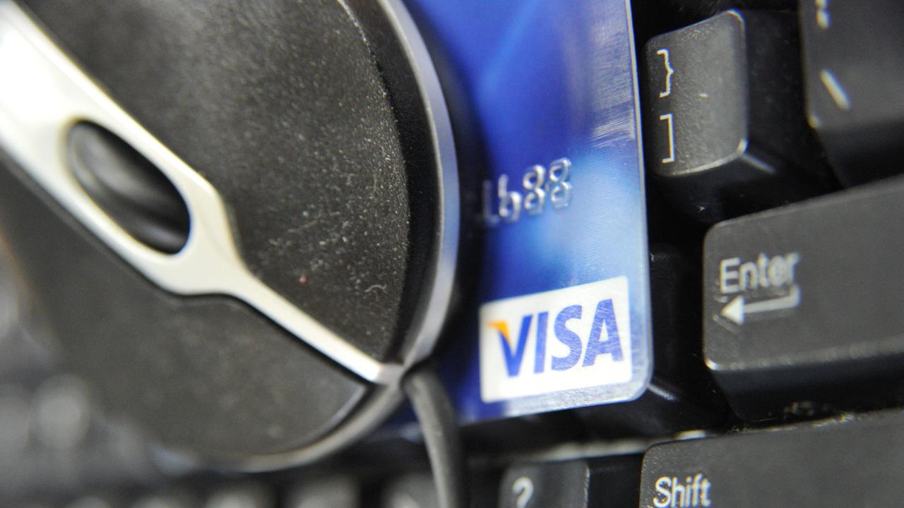 Feature picture of a Visa card, computer mouse and keyboard for internet scam story. Photo: Derrick Den Hollander