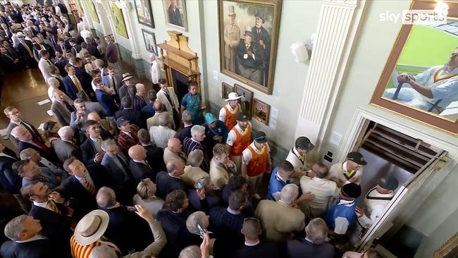 Usman Khawaja and Dave Warner in dispute with several MCC Members in the Long Room at Lords during the lunch break.