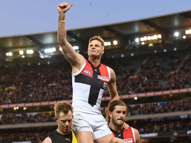 Nick Riewoldt was chaired from the ground by his Cousin Jack Riewoldt and Saints teammate Josh Bruce after the round 23 AFL match between the Tigers and Saints at the MCG in Melbourne. Picture: Julian Smith/AAP.