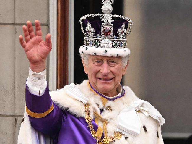 -- AFP PICTURES OF THE YEAR 2023 --  Britain's King Charles III wearing the Imperial state Crown, and Britain's Queen Camilla wearing a modified version of Queen Mary's Crown wave from the Buckingham Palace balcony after viewing the Royal Air Force fly-past in central London on May 6, 2023, after their coronations.. The set-piece coronation is the first in Britain in 70 years, and only the second in history to be televised. Charles will be the 40th reigning monarch to be crowned at the central London church since King William I in 1066. (Photo by Oli SCARFF / AFP) / AFP PICTURES OF THE YEAR 2023