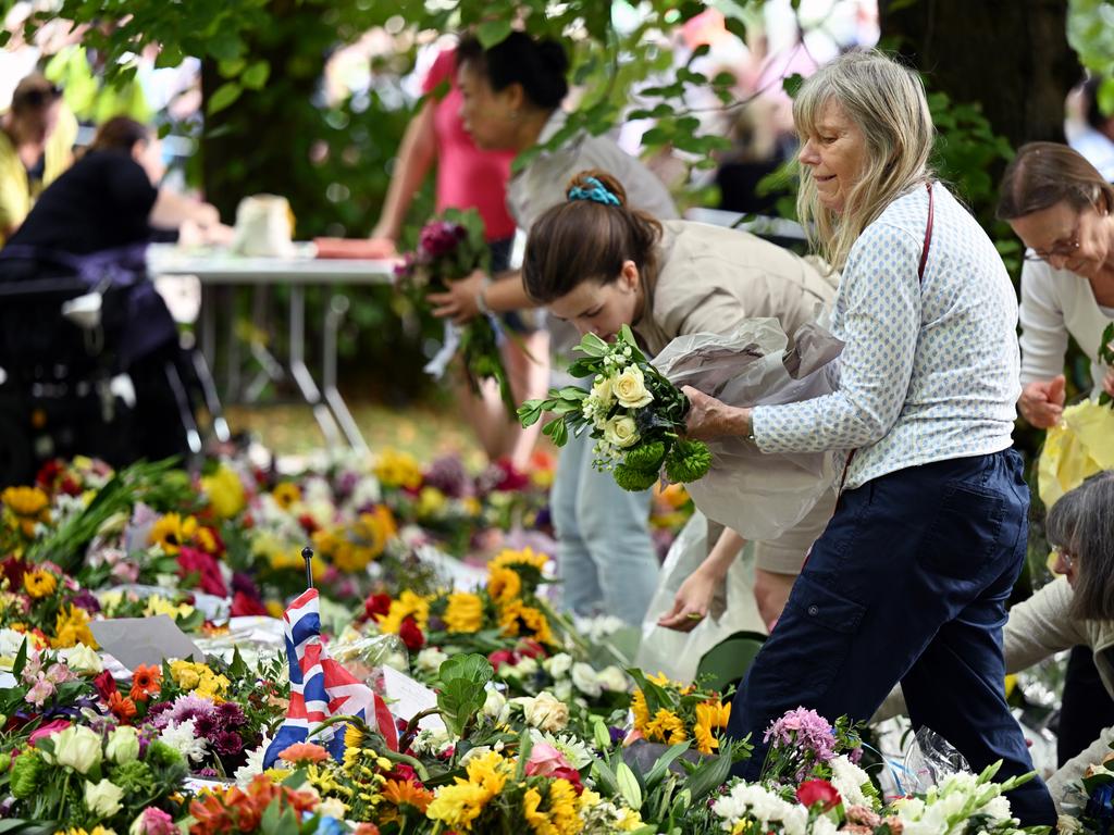 Volunteers remove the plastic from floral tributes to allow the flowers to be composted and the plastic recycled at Green Park in London. Picture: Jeff Spicer/Getty Images