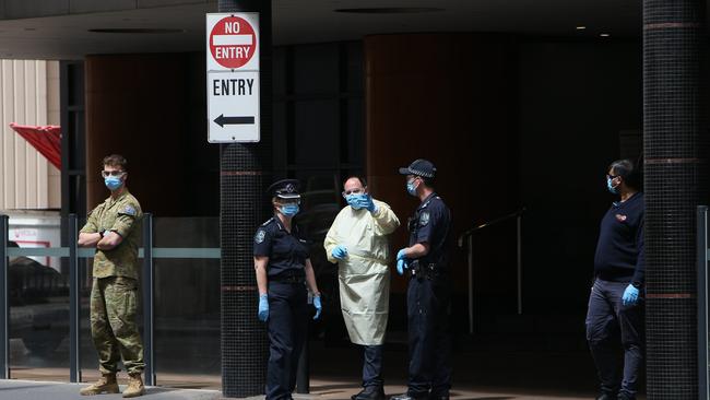 The Army, Police, Security and Heath officials escort individuals into COVID 19 quarantine at the Peppers Hotel on Wakefield Street, Adelaide, SA. Picture Emma Brasier.