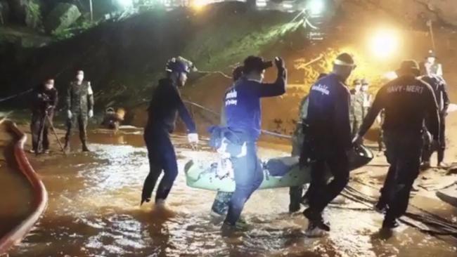 Rescuers hold ferry one of the boys through the Tham Luang Nang Non cave. The complex is set to become a museum. Picture: Thai Navy Seal Facebook Page via AP