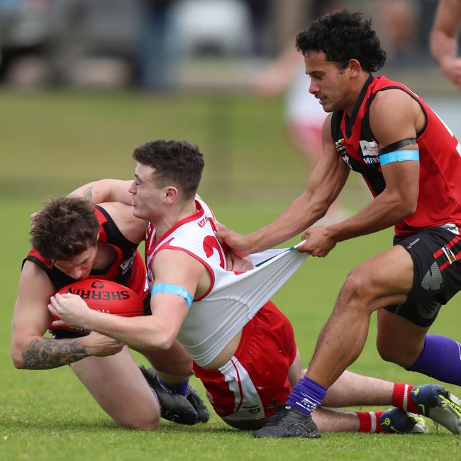 Ararat’s Tom Cousins is sandwiched between Stawell duo Jesse Barber and Riley Ika.