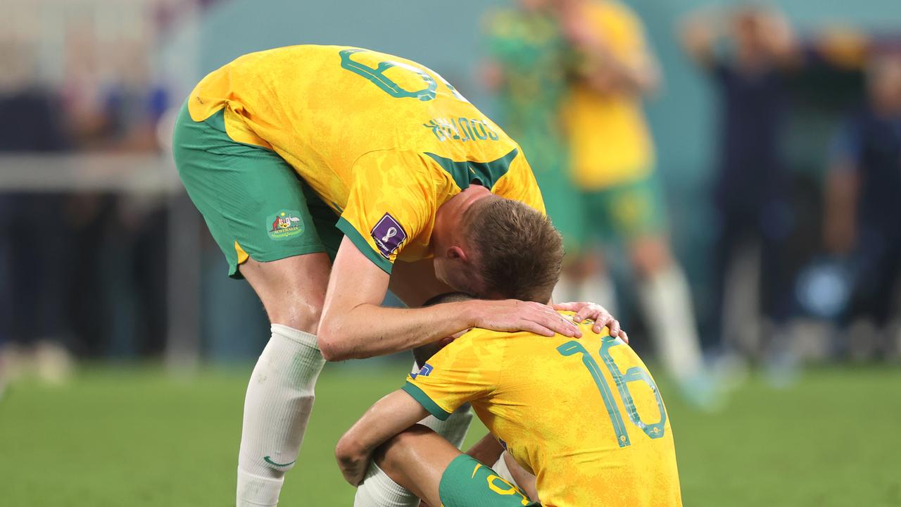 Harry Souttar and Aziz Behich of Australia look dejected after their sides' elimination from the tournament.