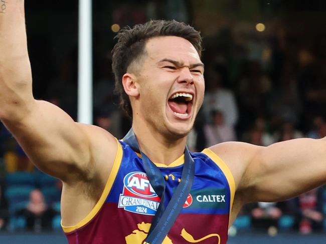 Cam Rayner celebrates after receiving his premiership medal on the dais. Picture Lachie Millard