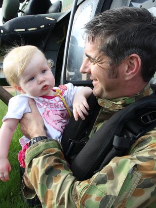 13-month-old Montannah Creaser reunited with Warrant Officer Class 2 Tony Young, member of the Blackhawk Army helicopter flight crew that carried her to safety.