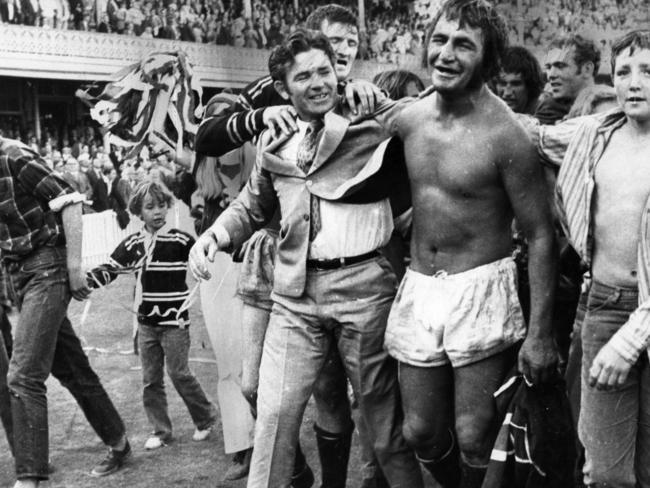 Coach Ron Willey (suit) and captain Fred Jones (no jersey) with other Manly players during lap of honour following the Manly Sea Eagles victory over Eastern Suburbs (Easts) in the 1972 Grand Final at the SCG in Sydney.