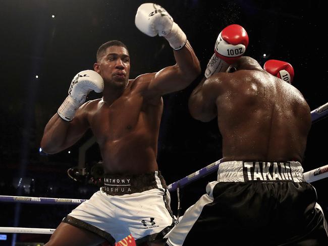 Britain's Anthony Joshua, left, and Cameroon's Carlos Takam fight during the IBF World Heavyweight Title, IBO World Heavyweight Title and WBA Super World Heavyweight Title bout at the Principality Stadium, Cardiff, Wales, Saturday, Oct. 28, 2017. (Nick Potts/PA via AP)