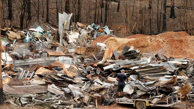 Residents of the busfire-ravaged town of Bobin drop off fire destroyed houses and sheds at a makeshift dump. Picture: Nathan Edwards