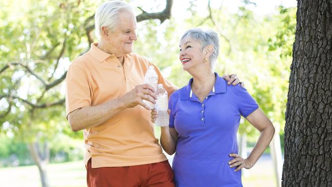 Active senior couple with  outdoors taking a break after some jogging