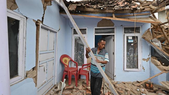 A man clears rubble from a house in Cugenang, Cianjur following a 5.6-magnitude earthquake that killed at least 268 people. Picture: AFP