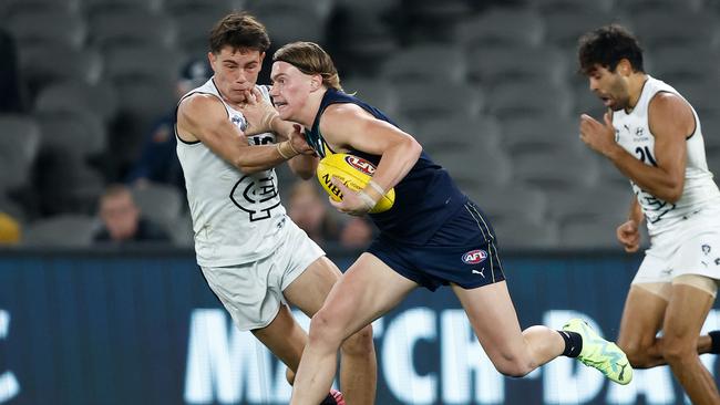 Harley Reid fends off an opponent with ease. Picture: Michael Willson/AFL Photos via Getty Images