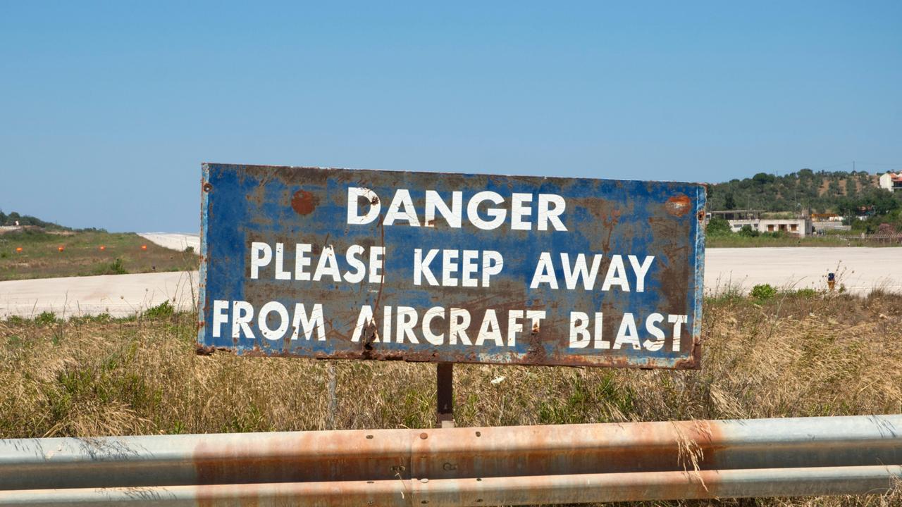 Warning signs do little to deter the plane spotters. Picture: Alamay