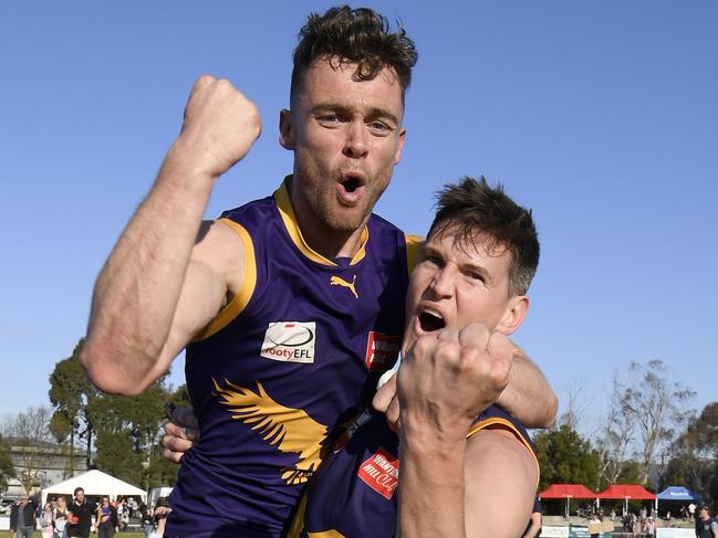 Former SANFL teammates Lachlan Carey and Andrew Ainger celebrate the grand final win. Picture: Andy Brownbill