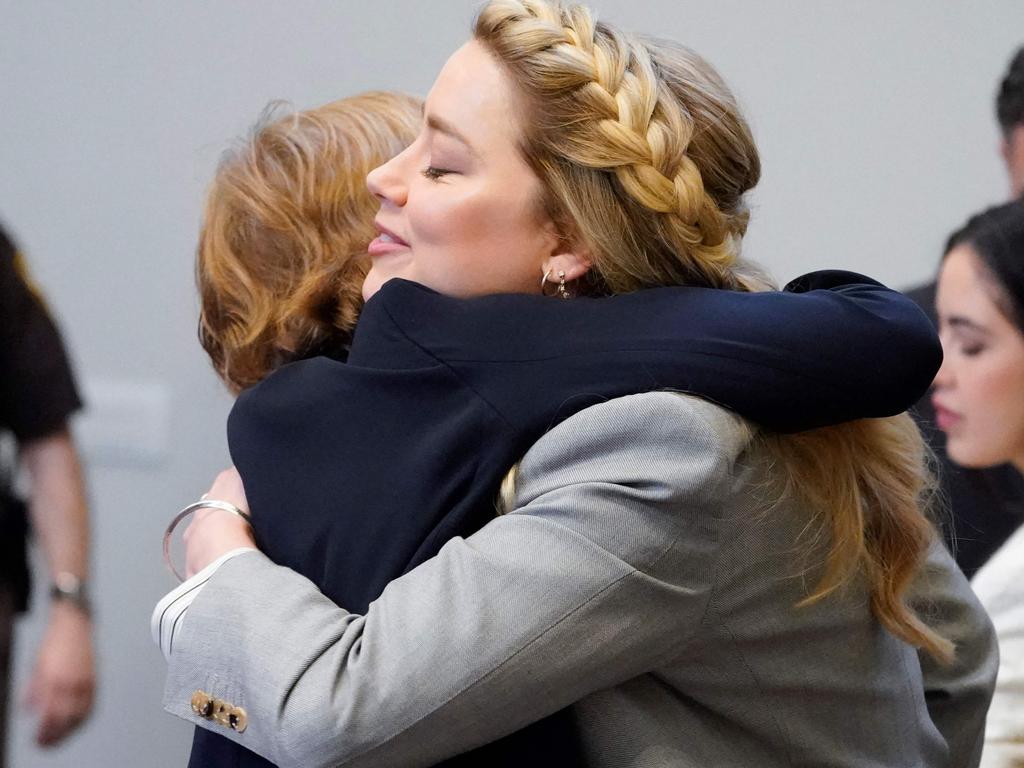 Amber Heard hugs one of her lawyers Elaine Bredehoft at closing arguments in the Depp v. Heard trial. Picture: Steve Helber / POOL / AFP