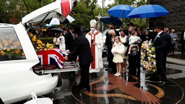 The family and Bert's grandkids take the casket out to a waiting car. Picture: Darrian Traynor/Getty Images