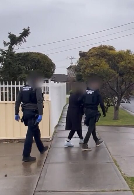 A Colombian woman is arrested by police.