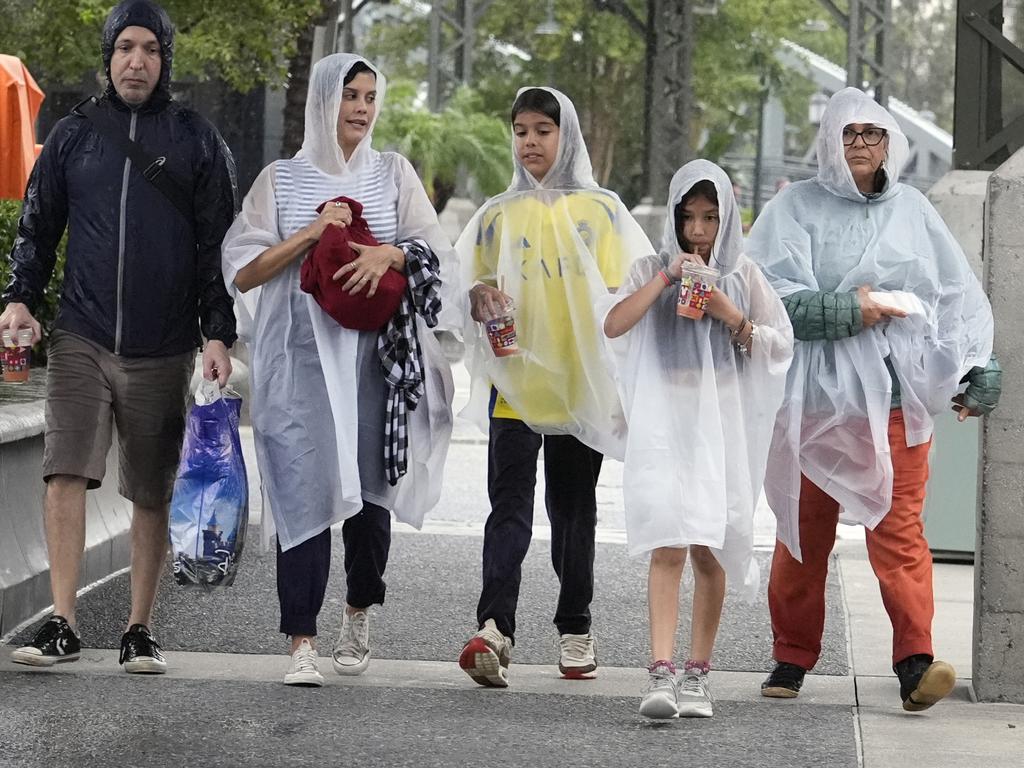 Tourists exit the Disney Springs entertainment complex before the arrival of Hurricane Milton. Picture: John Raoux/AP