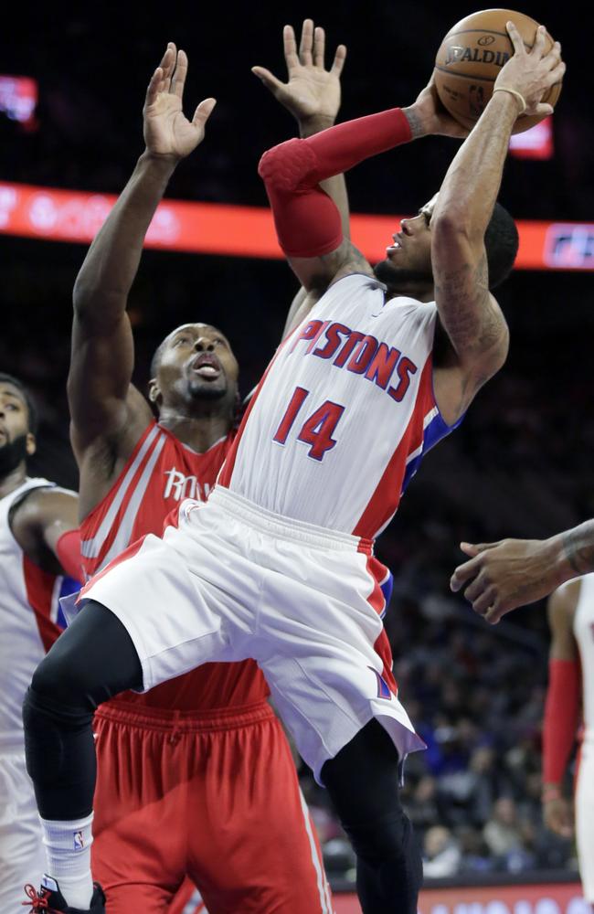 Detroit Pistons' D.J. Augustin (14) takes a shot against Houston Rockets' Joey Dorsey (8).