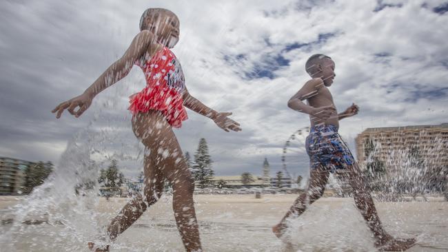 Hot Weather at Glenelg. Cooling off are Hlompho Kabi 8 (girl) and Keamohetswe Tsupa 10 (boy) 14th December 2024. Picture Brett Hartwig