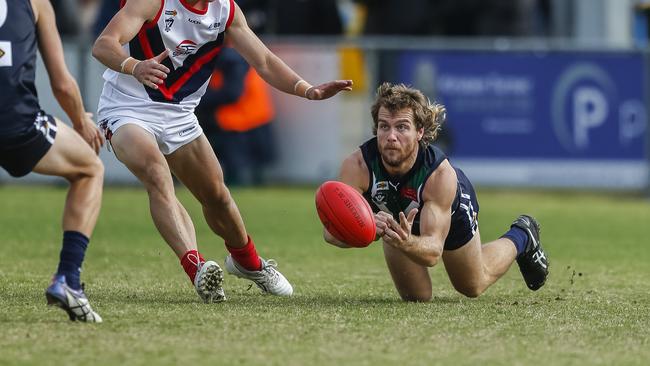 Jake Matthews gets  a handball away for AFL Yarra Ranges. Picture: Valeriu Campan