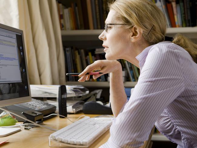 Woman studying computer screen. Generic image. Thinkstock.