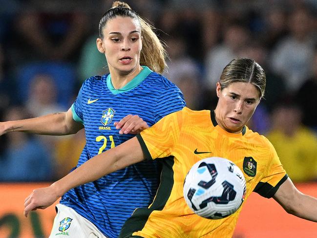 GOLD COAST, AUSTRALIA - DECEMBER 01: Kyra Cooney-Cross of Australia battles for possession with Giovana Queiroz of Brazil during the International Friendly match between the Matildas and Brazil at Cbus Super Stadium on December 01, 2024 in Gold Coast, Australia. (Photo by Bradley Kanaris/Getty Images)