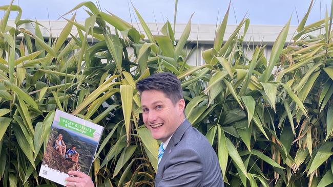 Cr Tim McMahon with a copy of the new Walks and Trails of Toowoomba Region Guide