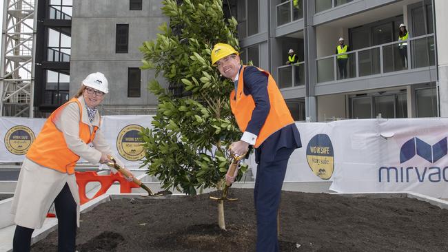 Mirvac CEO Susan Lloyd-Hurwitz and NSW Treasurer Dominic Perrottet in a physically distanced topping out at the Pavilions building site at Sydney Olympic Park. Picture: AAP