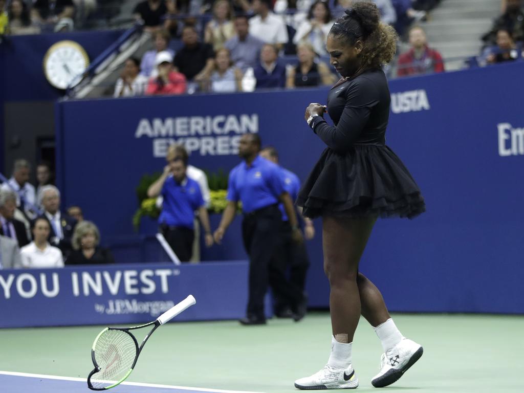 Serena Williams slams her racket on the court. (AP Photo/Julio Cortez)