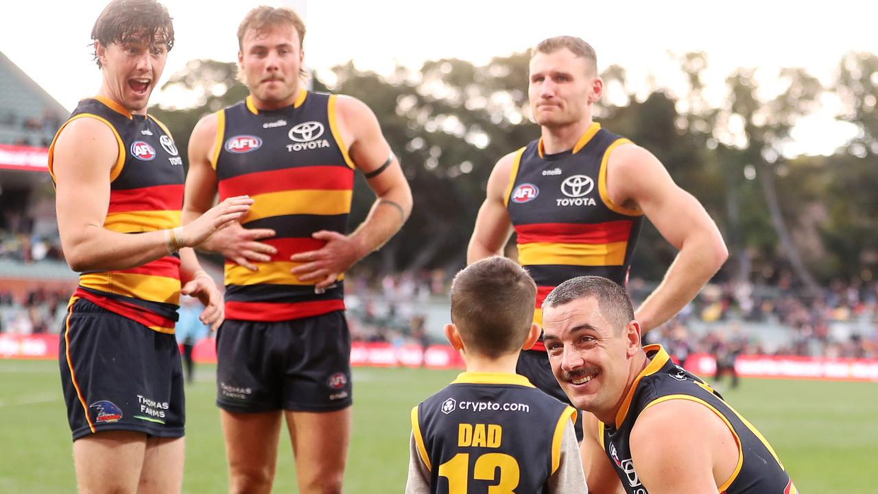 Taylor Walker and eldest son Hugo with Ned McHenry, Pedlar and Rory Laird after the win. Picture: Sarah Reed/AFL Photos via Getty Images