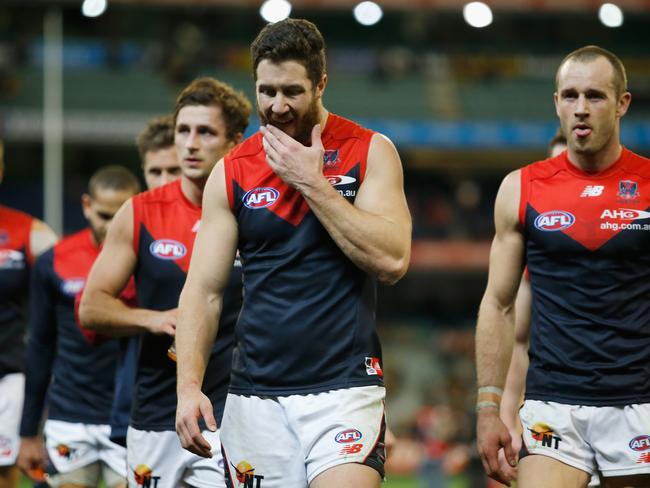 Dejected Melbourne players walk from the ground following the 50-point loss. Photo by Darrian Traynor