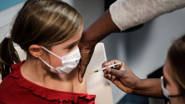 A child receives a dose of the Pfizer/BioNTech vaccine. Picture: AFP