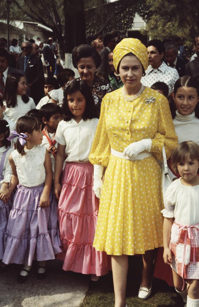 The Queen with a group of local children during her state visit to Mexico, 1975. Picture: Serge Lemoine/Getty Images