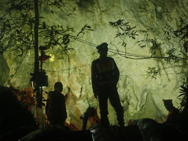 Thai police stand in front of the entrance to a cave complex where 12 boys and their soccer coach went missing more than a week ago. Picture: AP