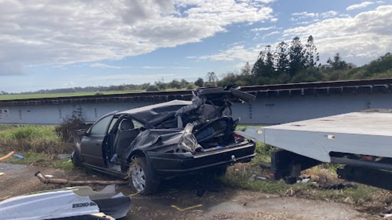 Two people died after a car crashed into a train track at Bundaberg Sunday morning.